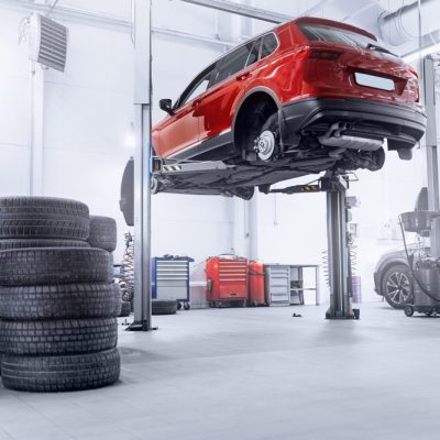 Concept,Car,Wheel,Service.,Professional,Mechanic,Changing,Tires,In,Garage. Concept,Car,Wheel,Service.,Professional,Mechanic,Changing,Tires,In,Garage.